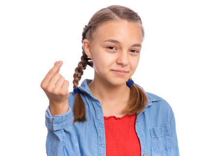 Happy teenage girl showing sign symbol of money by fingers, isolated on white backgroundの写真素材