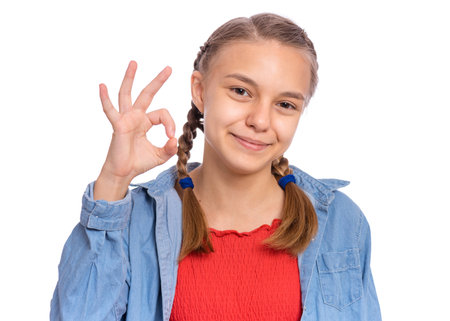 Happy teenage girl laughing looking very happy, isolated on white backgroundの写真素材