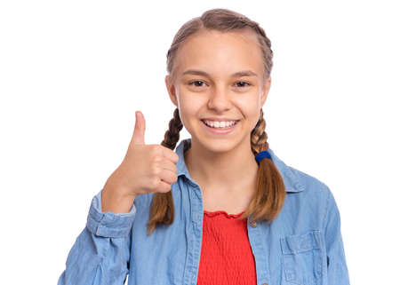 Happy teenage girl pointing up, gesturing idea or doing number one gesture, isolated on white backgroundの写真素材