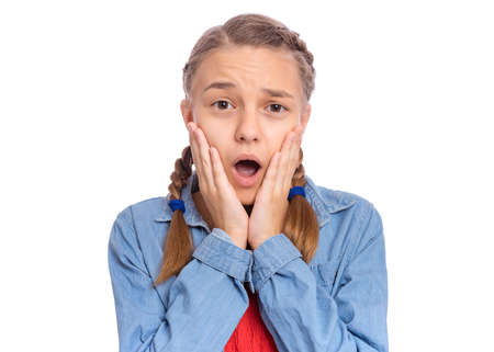 Emotional portrait of scared girl teenager, isolated on white backgroundの写真素材