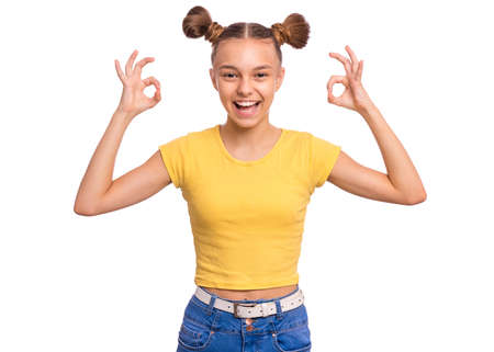 Happy teenage girl laughing looking very happy, isolated on white background. Laughing happy candid girl, showing okay OK sign.の写真素材
