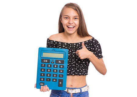 Smart female student holding big calculator and making Teen girl isolated on white. Happy cheerful child looking at camera. Back to school.の写真素材
