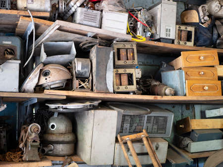 Full shelves of vintage equipment and things in abandoned garage, Clutter, unnecessary things