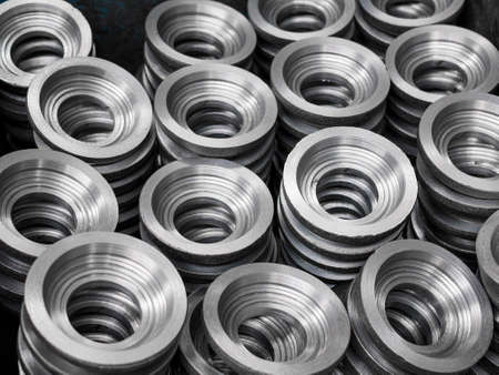 Piles of the gear blanks with bore, close up. Manufacturing of cylindrical gears