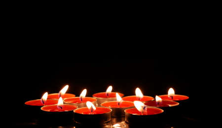 Group of candles. Combination of light and darkness. Ceremonial use of lights, copy spaceの写真素材