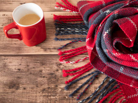 Warm tartan rug and a cup of coffee. Concept of cozy and warm atmosphere, copy spaceの写真素材