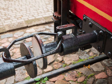 Old tram coupling on the background of cobblestone. Type of connection between tram cars, close upの写真素材