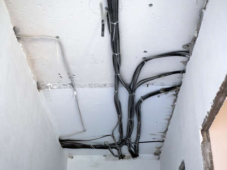 Electrical wiring on concrete ceiling. Repair the apartment without finishing. Electric cables