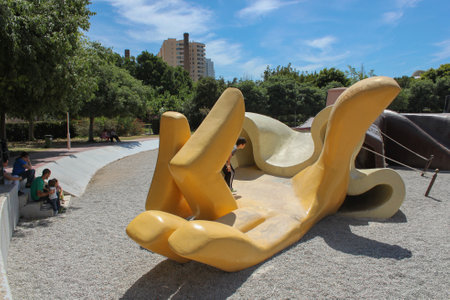 Valencia, Spain - 15 May 2014: Hand of large-scale fallen Gulliver where kids play. Children's playground Gulliver Parkのeditorial素材