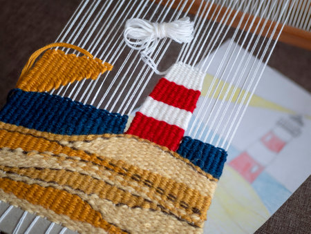 Making a tapestry with a picture of a lighthouse following the sketch, selective focus. Tapestry art...