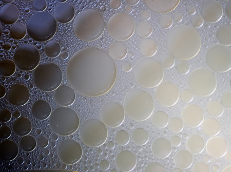 Clear broth surface, close up. Clear soup background. Texture of bubbles in the fluid