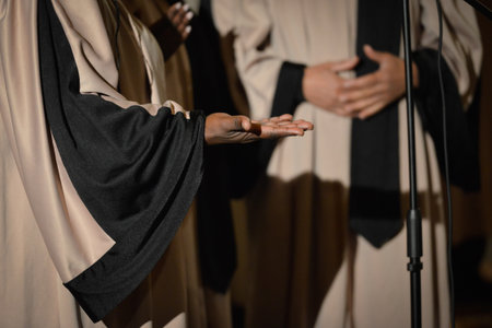Detail of an outstretched hand, emerging from a large robe, palm upwards, during a Gospel concertの写真素材