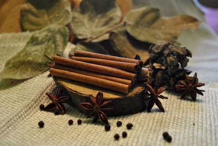 Pile of cinnamon sticks with anise and pepper