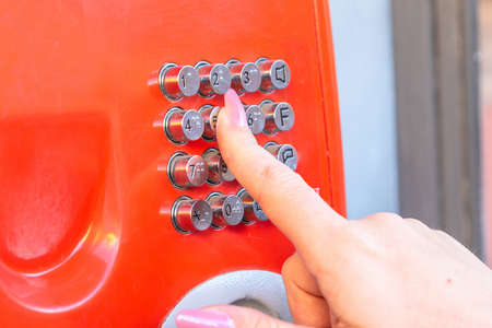 female finger on the phone button.の写真素材