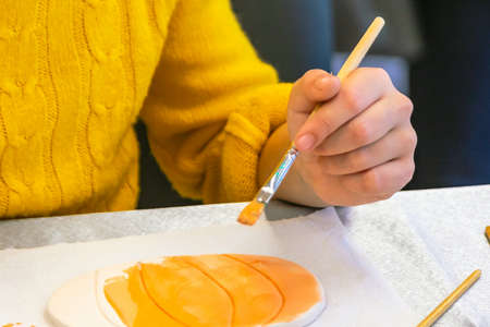 children's hand with a brush draws.の写真素材