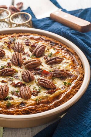 Open pie with cheese, bacon and pecans. Traditional American homemade cakes. Close up and vertical orientation.の写真素材