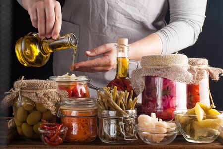 Woman makes homemade canned pickled and fermented vegetables for long-term storage. Preservation of...