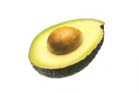 Cut avocado. Half an avocado with a large fruit seed in center. Isolate on a white background. Close-up. Template for design.の写真素材