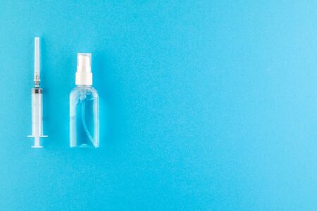 A set of hygienic antiseptics and medications on a blue background. Top view. Antibacterial...