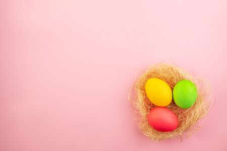 Beautiful easter eggs painted in yellow, red and green pastel colors on a pink background. Template...