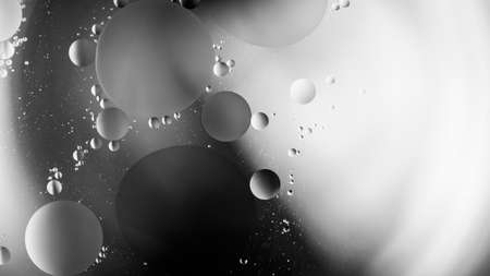 Abstract black and white background close-up. Template for design.Soft flowing shapes of circles of different diameters. Macro Photography. Selective focus.の写真素材