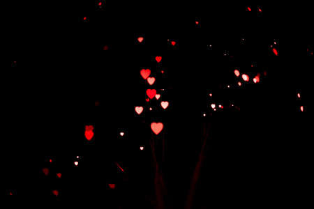 Garland in the form of a red heart glows on a black background. Holiday or valentine's day...