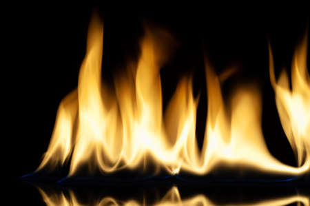 The fire. Flames are burning isolated on a black background. Template for design. Copy space and...