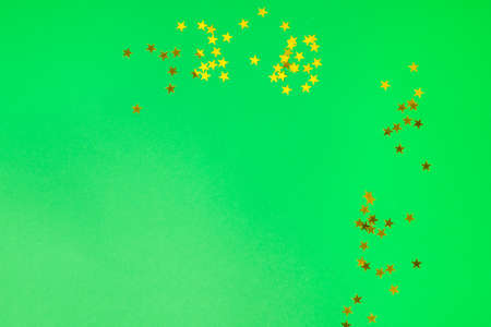 Christmas background. Decorative ornaments in the form of stars lie on a pastel green background....