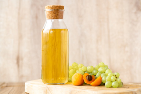 Homemade white wine or apple cider vinegar in a tall bottle with a wooden stopper. Eco-friendly food...