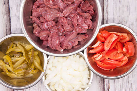 Sliced beef or pork meat with fresh vegetables top viewの写真素材