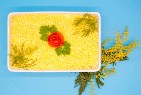 Mimosa salad. Layered salad of fish, eggs, cheese, butter, and boiled eggs. Traditional Russian...