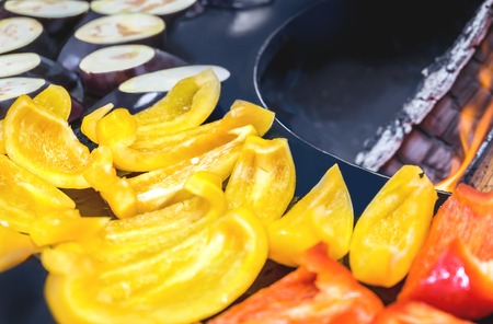 Pepper, corn, eggplant, kebabs, chicken on a street grill on an open fire. Summer food
