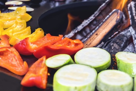 Peppers, aubergines, zucchini on the grill on an open fire. Summer food