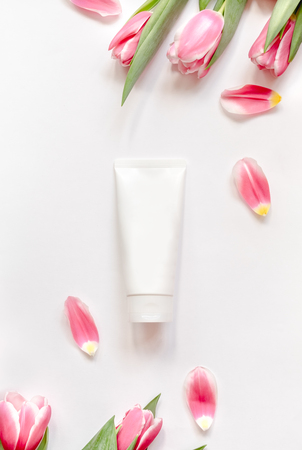 Natural organic cosmetic packaging plastic mock up with leaves and flowers. Mock-up bottle for branding and label.の写真素材