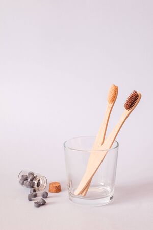 Bamboo toothbrush and dry tooth paste or toothpaste tablets on blue background. Zero waste, ecological concept.の写真素材