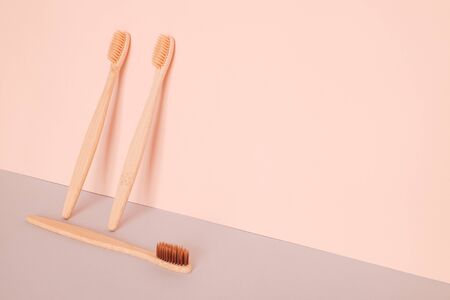 Bamboo toothbrush on pink blue background. Zero waste, ecological concept.の写真素材