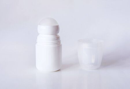 Mock up a bottle of deodorant with shadow. Light background