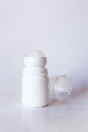 Mock up a bottle of deodorant with shadow. Light backgroundの写真素材