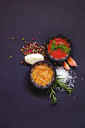 Various herbs and spices on dark background, top viewの写真素材
