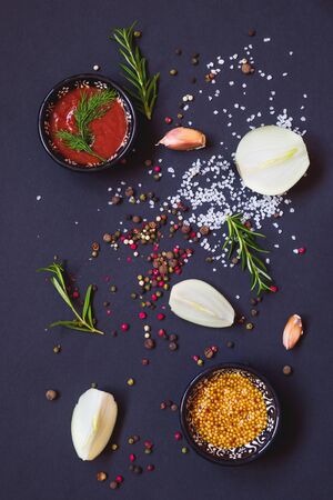 Various herbs and spices on dark background, top viewの写真素材