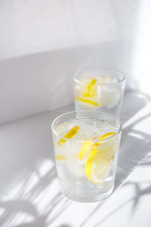 Lemon water with fresh lemons. Water balance in the body.の写真素材