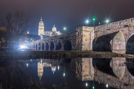 Night view of the Cathedral of Salamanca, Spain and its reflection in the river Tormesの写真素材