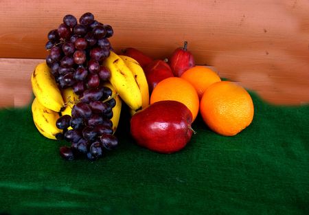 Fruit Salad fruits grouped on table against wood backgroundの写真素材