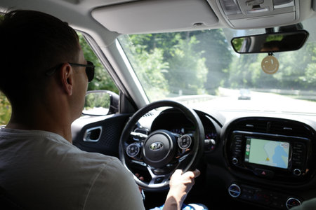 Young man driving a car. View from the driver's seat.のeditorial素材