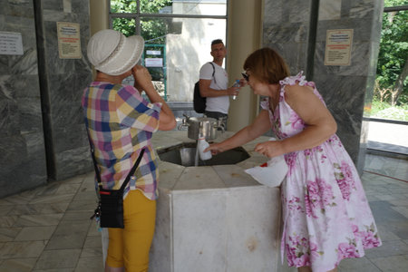 Unidentified people drinking water from a fountain in Novi Sad, Serbia