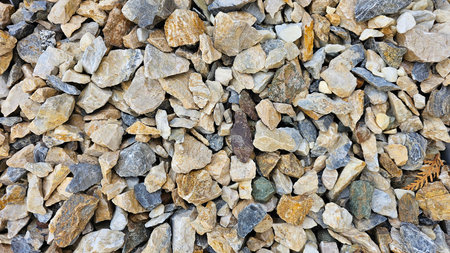 Pile of stone pebbles as a background texture pattern.