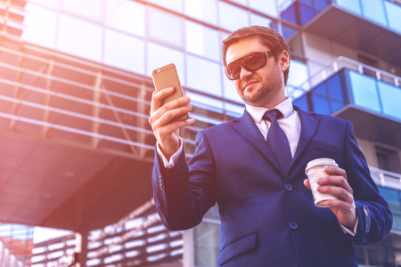businessman with smartphone and coffeeの写真素材