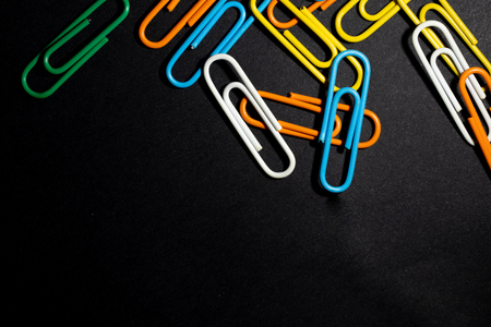 color paperclip on black backgroundの写真素材