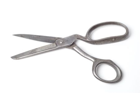 A pair of old scissors isolated on a black background