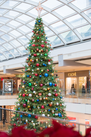 Big Christmas tree decorated with lights and toys on ice rinkin Galleria Shopping Mall, Houston, Texasのeditorial素材